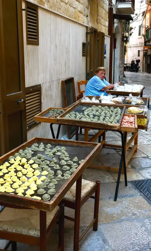 Traditional Italian pasta making in a local street setting